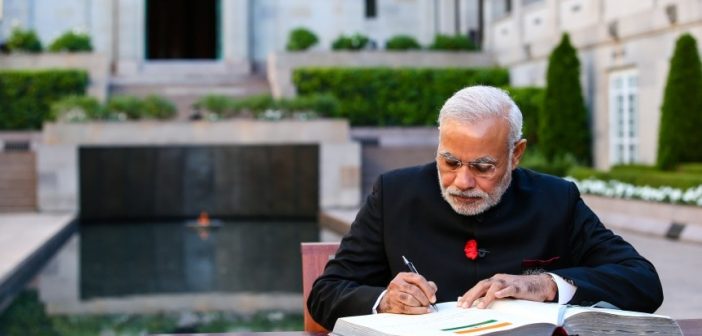Modi begins crucial reforms of India’s bureaucracy Narendra Modi writing a book 702x336
